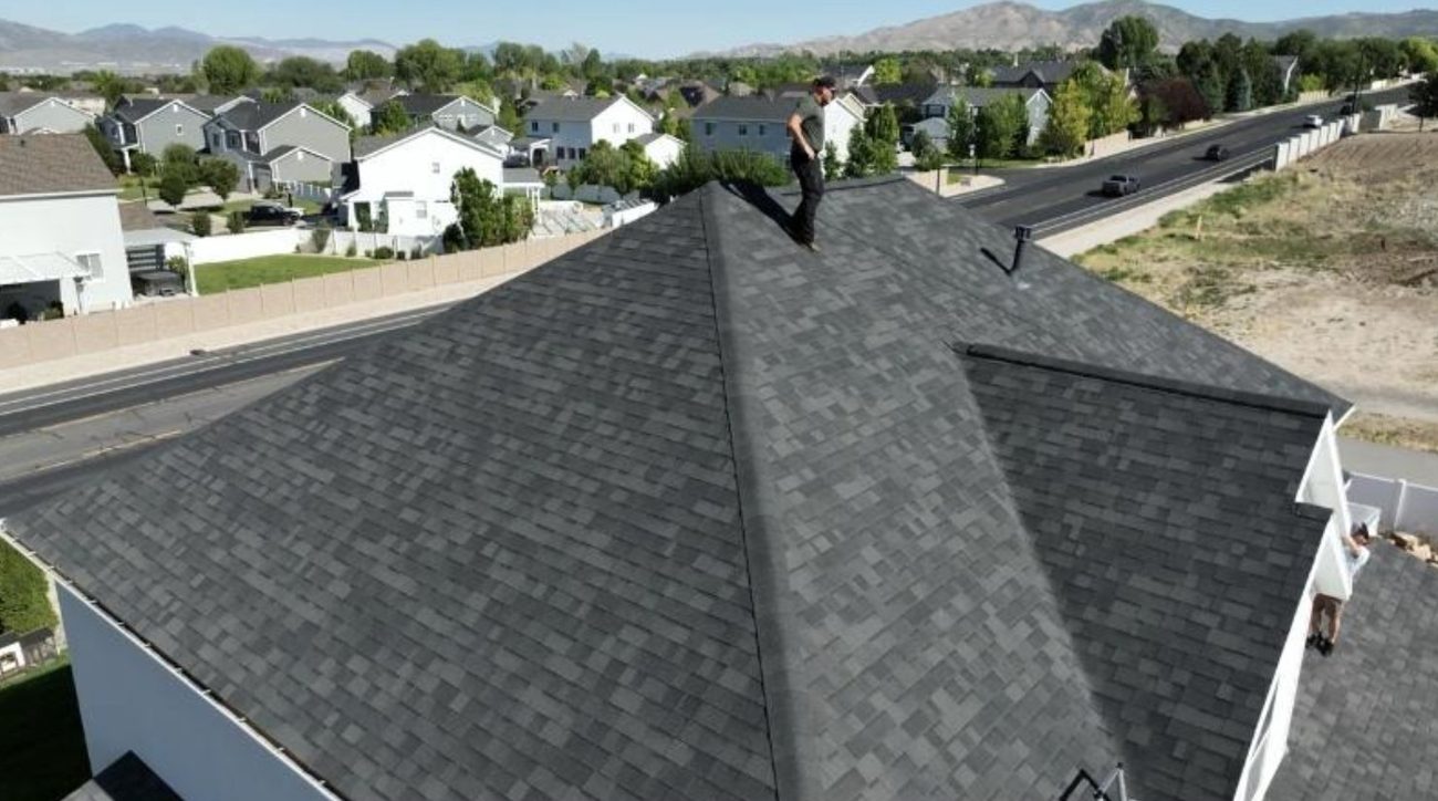 Aerial view of a crew restoring an asphalt shingle roof